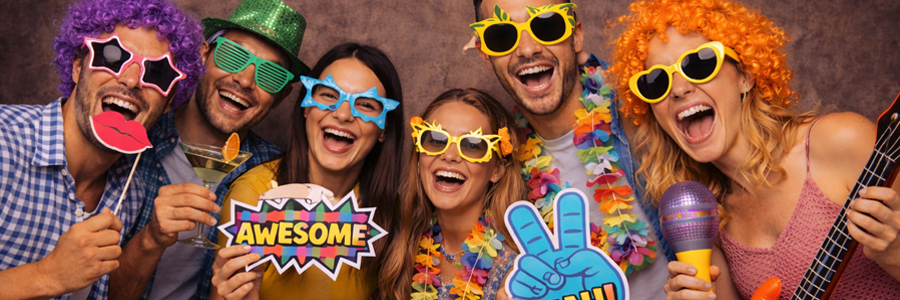 Happy guests with props in front of the photo booth